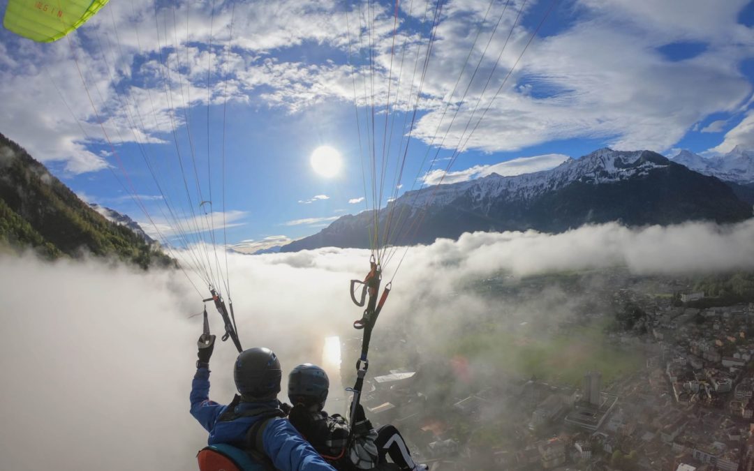 SOAR INTO THE SUN: A SUNNY INTERLAKEN PARAGLIDING PERSPECTIVE